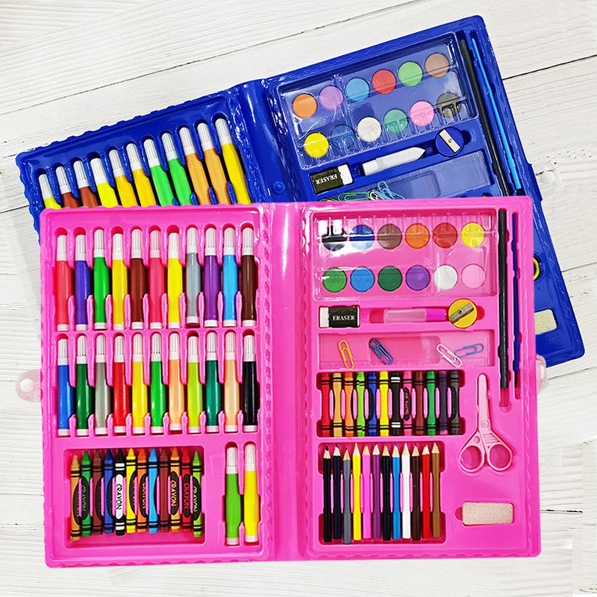 Open art kit with various tools including crayons, markers, and paint on a white wooden surface.