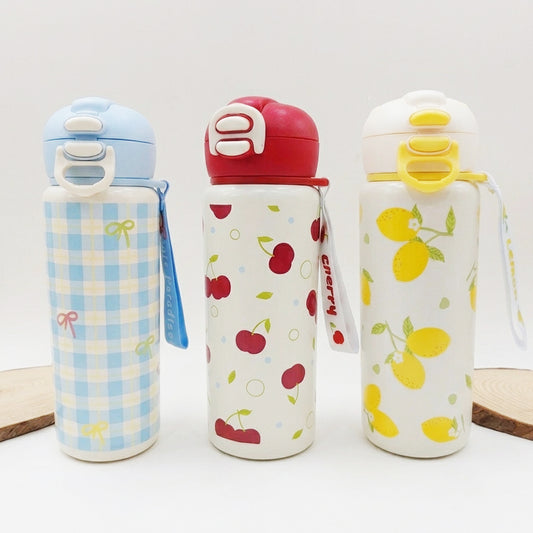 Three reusable stainless steel water bottles with lids are lined up on a white surface. The left bottle has a light blue and white gingham pattern with a light blue lid.