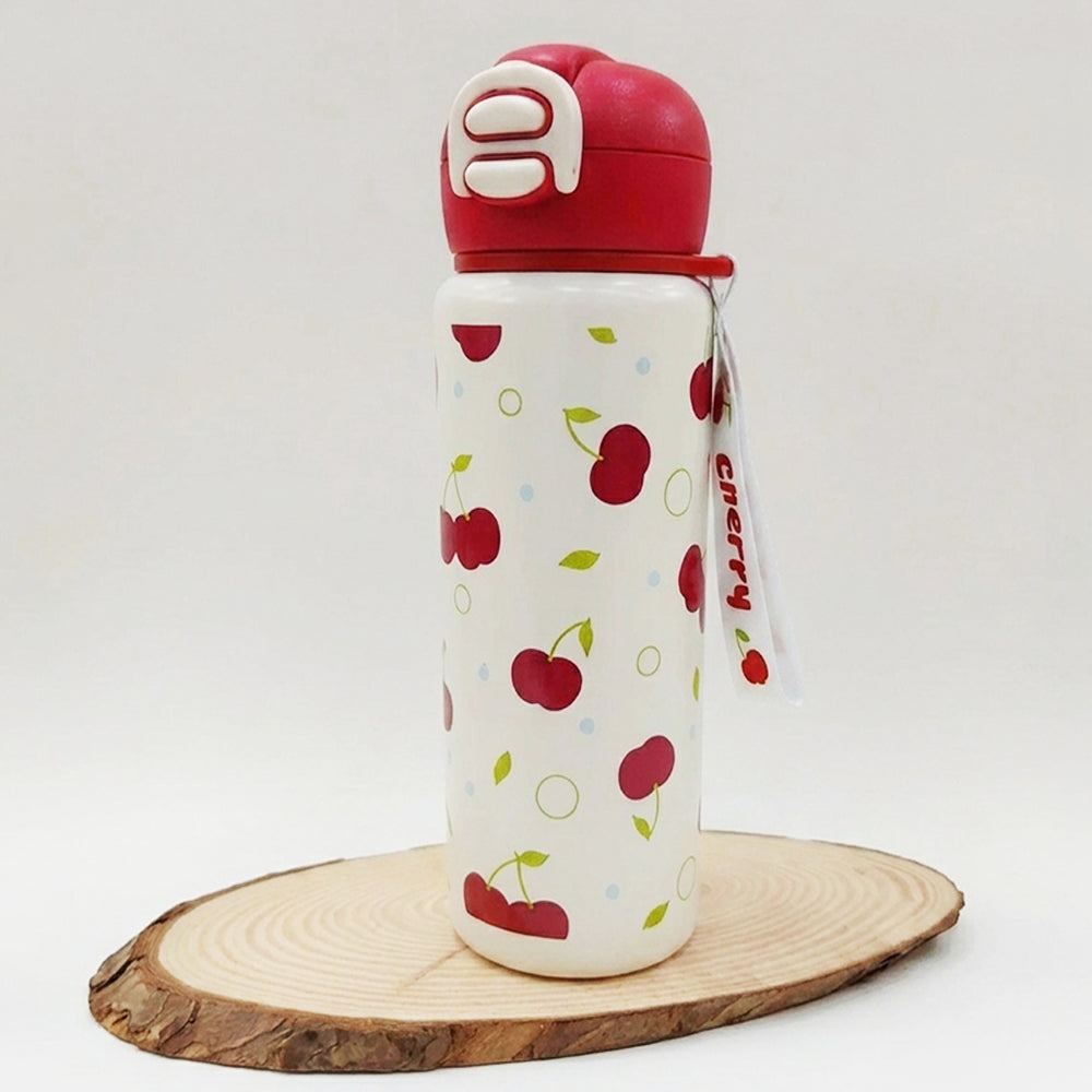 A white insulated water bottle with a red lid and a cherry pattern, displayed on a round wooden slice against a white background.