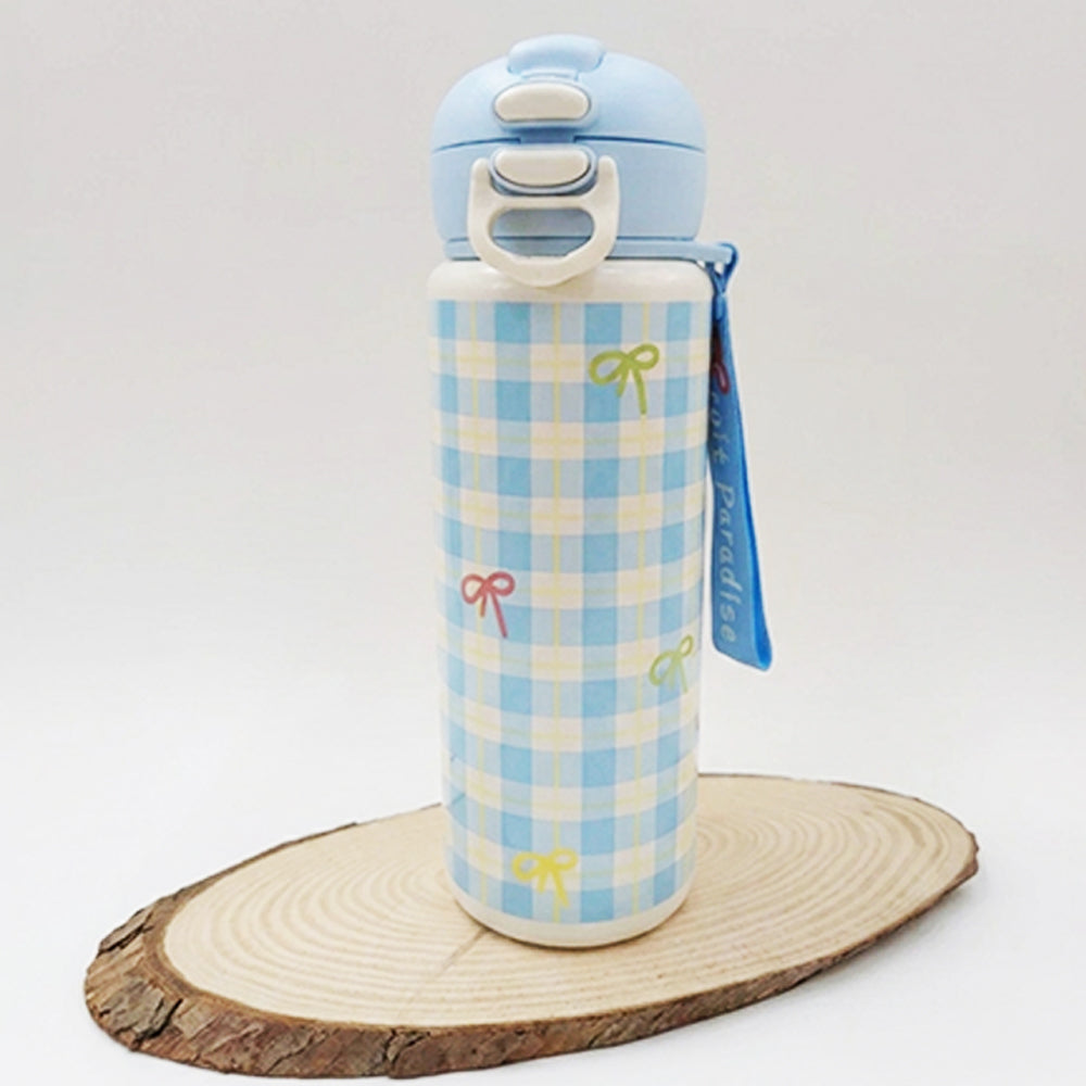 A light blue and white checkered water bottle with small bow accents, displayed on a round wood slice coaster against a plain white background.